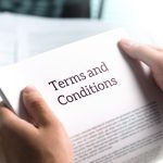 Terms and conditions text in legal agreement or document about service, insurance or loan policy. Lawyer or client holding contract paper in office.