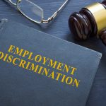 Law about employment discrimination and a gavel on the table.