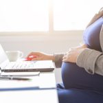 pregnant woman is working on computer laptop and mobile phone, business