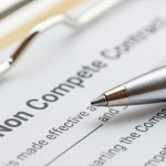 Legal concept : Blue ballpoint pen on a non compete contract. Noncompete contract is an agreement between employee and employer, not to enter into competition in subsequence business effort.