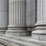 Stone colonnade and stairs detail. Classical pillars row in a building facade, New Yotk USA