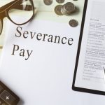 Paper with Severance Pay on a table