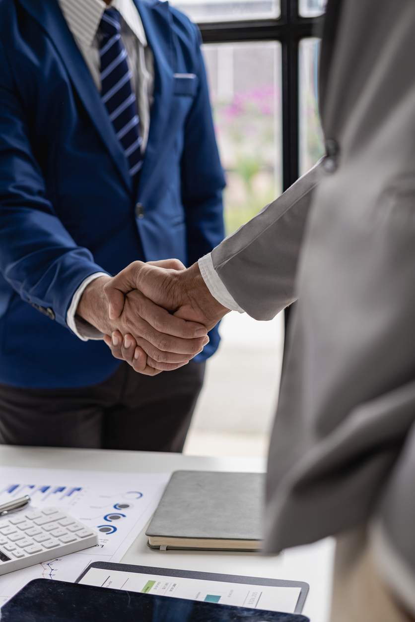 Business handshake for teamwork of business mergers and acquisitions. Successful negotiations, handshakes, distant pictures