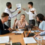 Workplace Conflicts. Stressed Group Of Business People Having Disagreements During Corporate Meeting, Brainstorming Together In Boardroom, Two Male Coworkers Emotionally Discussing Financial Report